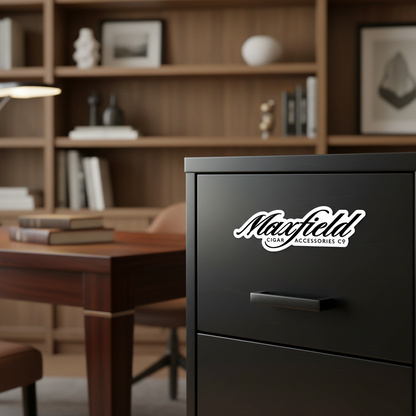 Black file cabinet with 'Maxfield' logo on a magnet, in a room with wooden shelves and books.