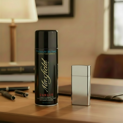 Maxfield Premium Butane can on a table with a lighter and writing utensils.